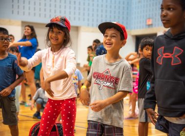 A boy and girl enjoying camp activities in the gymnasium