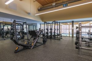 Several fitness machines organized in a room.