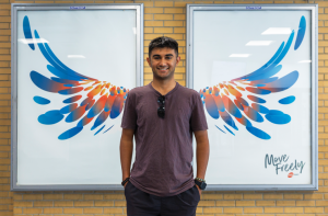Boy standing in front of bird wings at City Centre Transit Terminal