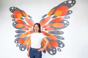 Girl posing in front of butterfly wings at City Centre Transit Terminal