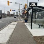 Stop #0224 - 2 metre standard 4-post shelter with a landing Pad and sidewalk