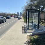 Stop #3032 - 1.8 metre standard 4-post shelter with sidewalk landing pad and concrete retaining wall