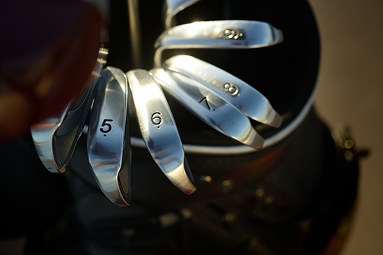 Close up of a set of golf clubs in a golf bag.