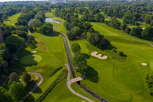 Aerial view of Lakeview Golf Course greens surrounded by trees.
