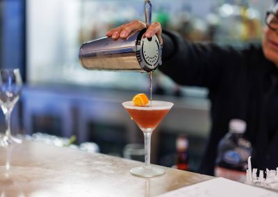 Bartender pouring a beverage on the bar