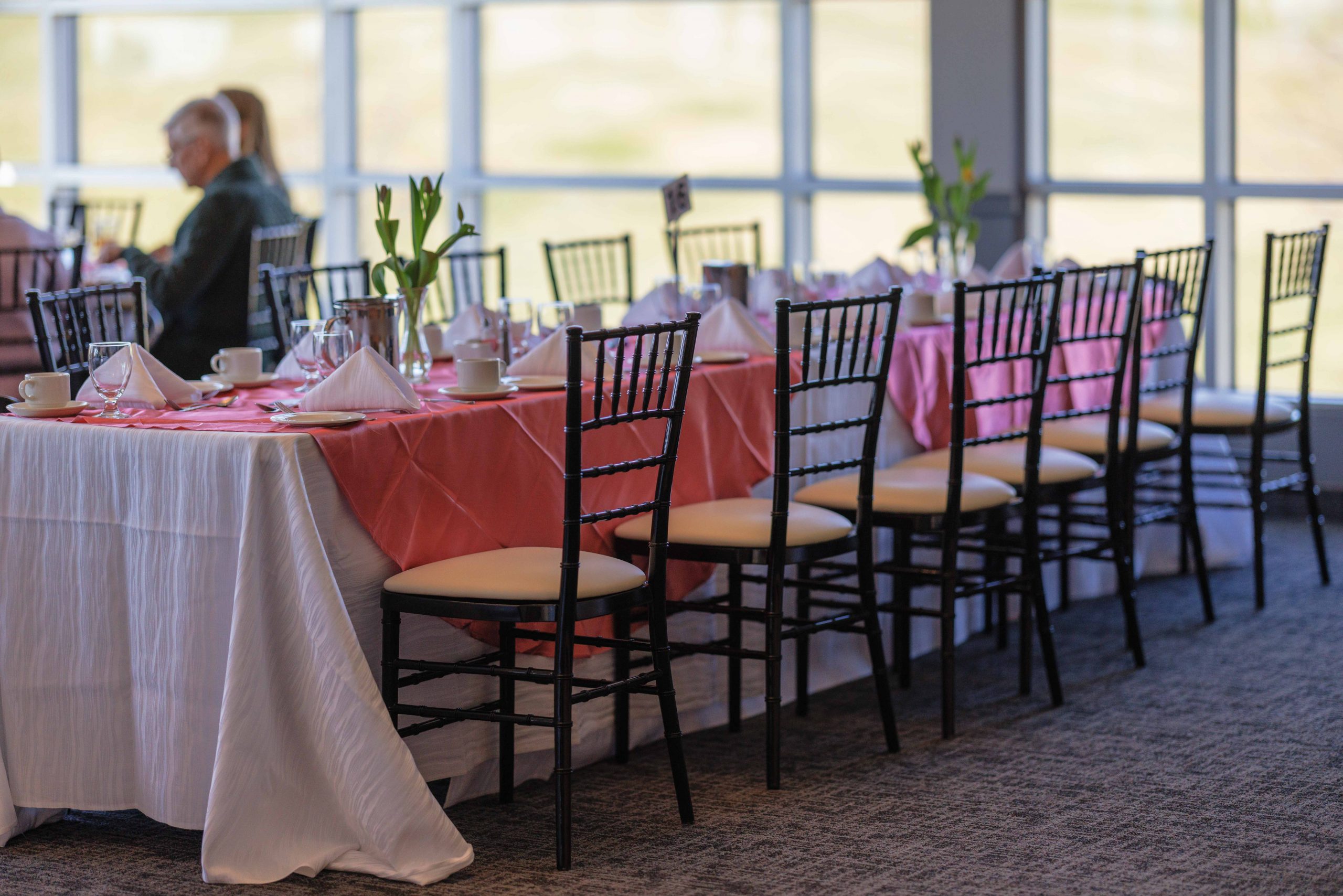 Chiavari chairs setup at a table with pink and white linens