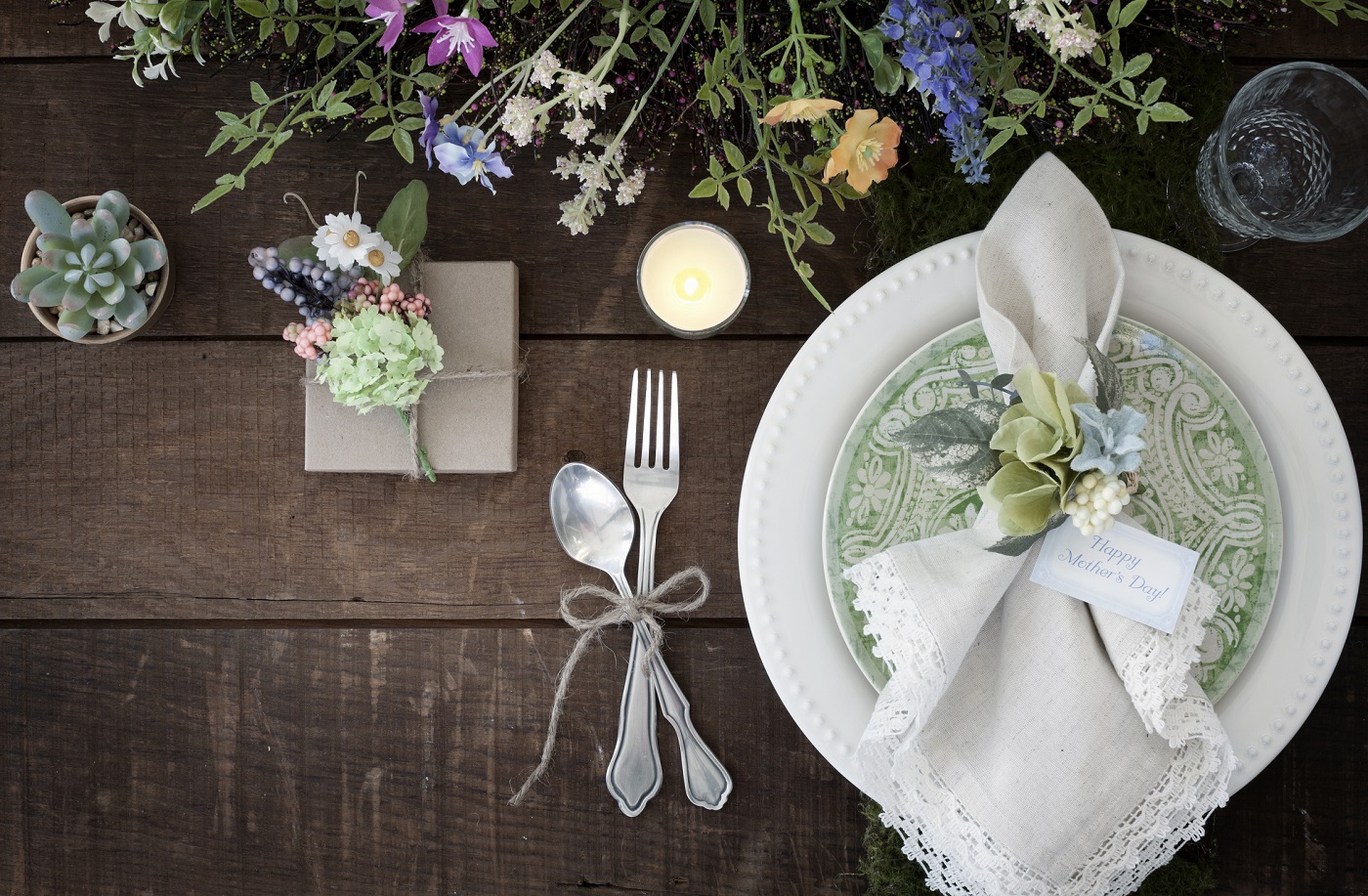 Mother’s Day dining place setting and flowers on old wood table