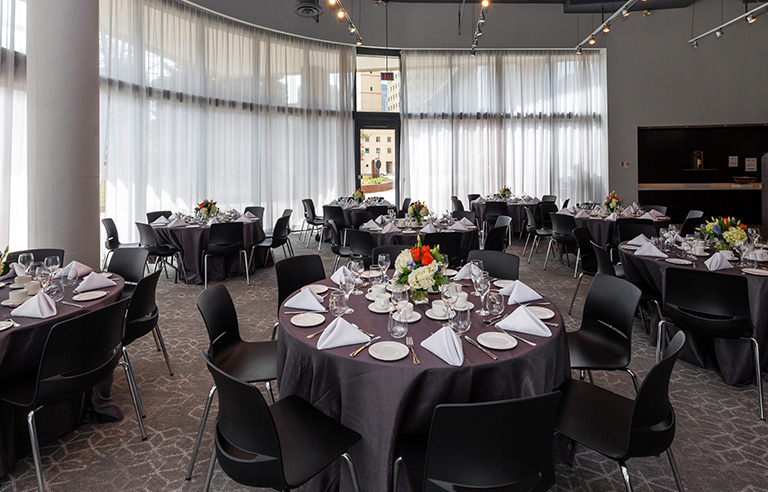 Curtained windows provide natural light in restaurant dining room